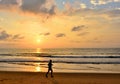 Silhouette of men are jogging on the beach sunset background Royalty Free Stock Photo