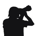 Silhouette of a men held camera