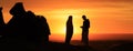 Silhouette of men standing in the desert at sunset Royalty Free Stock Photo