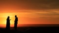 Silhouette of men standing in the desert at sunset Royalty Free Stock Photo