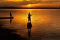 Silhouette, men standing, fishing At the Mekong River at sunset Royalty Free Stock Photo