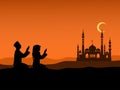 Silhouette of Men and women of Islam sit on the hill to pray at sunset. With Islamic churches and mountains in the background