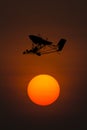 Silhouette microlight aircraft with sunset background Royalty Free Stock Photo