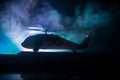 Silhouette of military helicopter ready to fly from conflict zone. Decorated night footage with helicopter starting in desert with Royalty Free Stock Photo