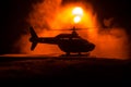 Silhouette of military helicopter ready to fly from conflict zone. Decorated night footage with helicopter starting in desert with Royalty Free Stock Photo