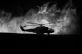 Silhouette of military helicopter ready to fly from conflict zone. Decorated night footage with helicopter starting in desert with Royalty Free Stock Photo