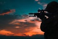 Silhouette of a military soldier with weapons at sunset Royalty Free Stock Photo