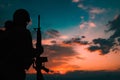 Silhouette of a military soldier with weapons at sunset Royalty Free Stock Photo