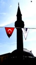 A silhouette of a minaret with a Turkish flag Royalty Free Stock Photo