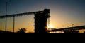 Silhouette of a mining silo and conveyor belts