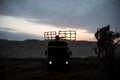 Silhouette of mobile air defence truck with radar antenna during sunset. Satellite dishes or radio antennas against evening sky Royalty Free Stock Photo