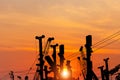 Silhouette of Mobile construction cranes with yellow telescopic arms and big tower cranes, truck cranes sunset sky background Royalty Free Stock Photo