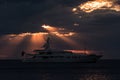 Silhouette of a modern yacht under a cloudy sky