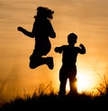 Silhouette of Mom and son in the rays of sunset