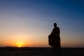 Silhouette of monk feet walking on concrete ground for people of