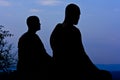 Silhouette of monk meditating