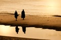 Silhouette of monk walking on Huahin beach