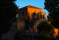 Silhouette of the monument and sculpture of Lazarillo de Tormes dimly illuminated by the golden twilight of the evening and the