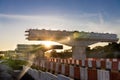 Silhouette with morning sun rays on highway overpass bridge infrastructure under construction Royalty Free Stock Photo