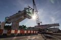 Silhouette with morning sun rays on highway overpass bridge infrastructure under construction Royalty Free Stock Photo