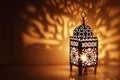 Silhouette of Moroccan ornamental lantern with burning glowing candle. Decorative shadows. Festive greeting card