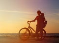 Silhouette of mother and baby biking at sunset Royalty Free Stock Photo