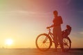 Silhouette of mother and baby biking at sunset Royalty Free Stock Photo