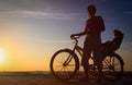 Silhouette of mother and baby biking at sunset Royalty Free Stock Photo