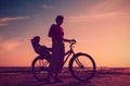 Silhouette of mother and baby biking at sunset Royalty Free Stock Photo