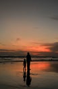 the silhouette of mother and child at the Parangtritis beach in Yogyakarta Indonesia