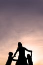 Silhouette of Mother and Children Dancing at Sunset Royalty Free Stock Photo