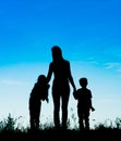 silhouette mother and children holding hands at sunset Royalty Free Stock Photo