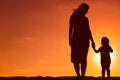 Silhouette of mother and daughter holding hands at sunset Royalty Free Stock Photo