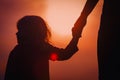 Silhouette of mother and daughter holding hands at sunset Royalty Free Stock Photo