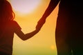 Silhouette of mother and daughter holding hands at sunset Royalty Free Stock Photo