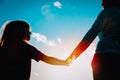 Silhouette of mother and daughter holding hands at sunset Royalty Free Stock Photo