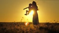 Silhouette of a mother with a small child against the sunset sky. Happy motherhood life with daughter. A woman on Royalty Free Stock Photo