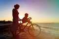 Silhouette of mother and son biking at sunset Royalty Free Stock Photo