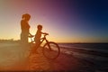 Silhouette of mother and son biking at sunset Royalty Free Stock Photo