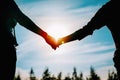 Silhouette of mother and son holding hands at sunset Royalty Free Stock Photo