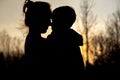 Silhouette of a mother and son playing outdoors at sunset. Mother`s day concept Royalty Free Stock Photo