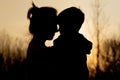 Silhouette of a mother and son playing outdoors at sunset. Mother`s day concept Royalty Free Stock Photo