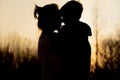 Silhouette of a mother and son playing outdoors at sunset. Mother`s day concept Royalty Free Stock Photo