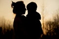 Silhouette of a mother and son playing outdoors at sunset. Mother`s day concept Royalty Free Stock Photo