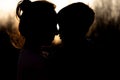 Silhouette of a mother and son playing outdoors at sunset. Mother`s day concept Royalty Free Stock Photo