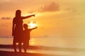 Silhouette of mother and son at sunset beach Royalty Free Stock Photo