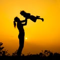 Silhouette of a mother and son who play outdoors at sunset Royalty Free Stock Photo