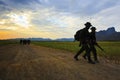 Silhouette motion of long range patrolling soldier walking on di