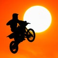 Silhouette of motocross rider jump in the sky Royalty Free Stock Photo