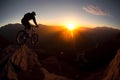 Silhouette of motorbike rider doing stunt on rocky mountain as jump cross slope of mountain with sunset backlit Royalty Free Stock Photo